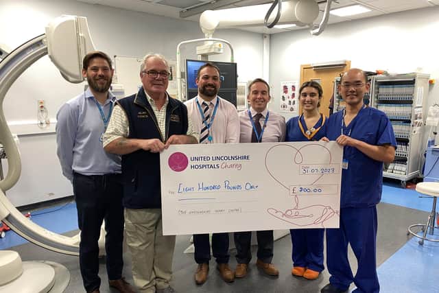 Alan Pearce presenting a cheque to Professor Kelvin Lee and other colleagues from United Lincolnshire Hospitals NHS Trust.