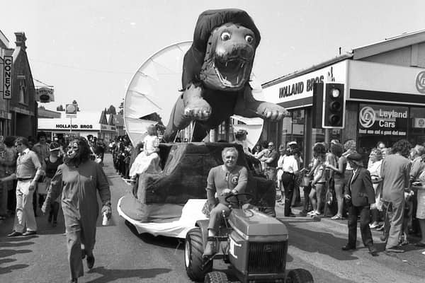 Boston Lions' larger-than-life lion heading the parade and carrying the Carnival Queen, Cindy Leach, and her attendants.