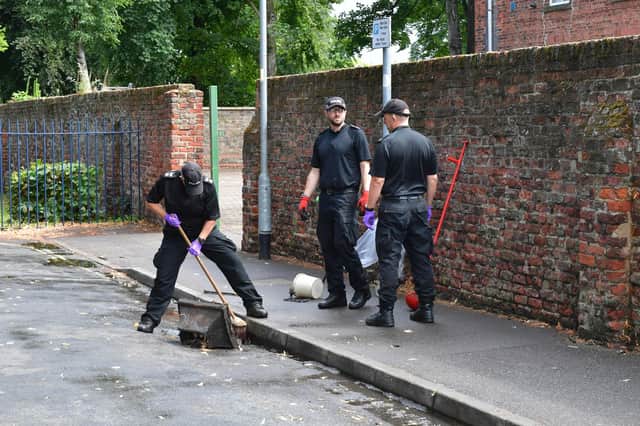 Police searching a drain near Central Park, in Boston, yesterday.