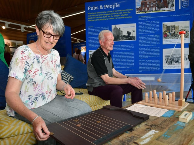Wendy and Steve Renshaw enjoying a traditional pub game at the Inns on the Edge exhibition. . Steve is secretary of the Lincoln branch of CAMRA