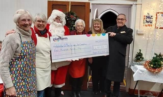 Wainfleet St Mary’s Community Hall Committee members, Maureen Clarke, Jan Ward, Santa, Ann Proctor, Christine Alexander and Mick Rust are pictured receiving the £400 donation from Platform’s Community Kindness Campaign during Tea with Santa.