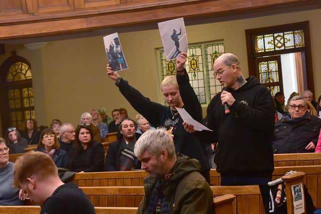 Members of the public address the panel with their concerns.