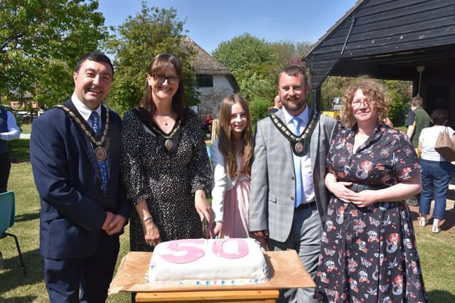 Civic guests cut the 50th anniversary cake, with manager Naomi Walton (right).
