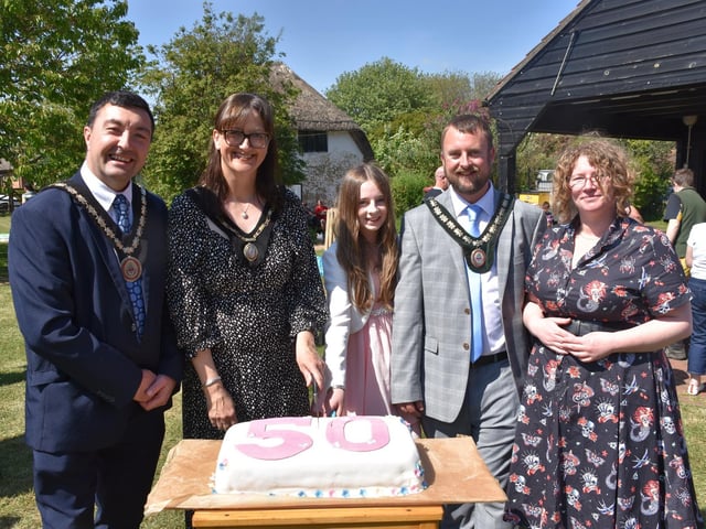 Civic guests cut the 50th anniversary cake, with manager Naomi Walton (right).