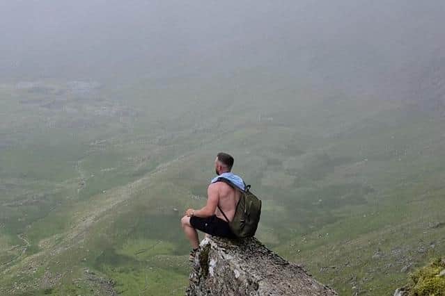 Dan Hart surveys the spectacular scene from the top of Mount Snowdon during one of his mountaineering adventures in the UK.