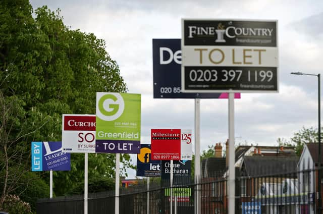 A variety of To Let, Let By and Sold estate agent signs outside houses in Richmond upon Thames, London.