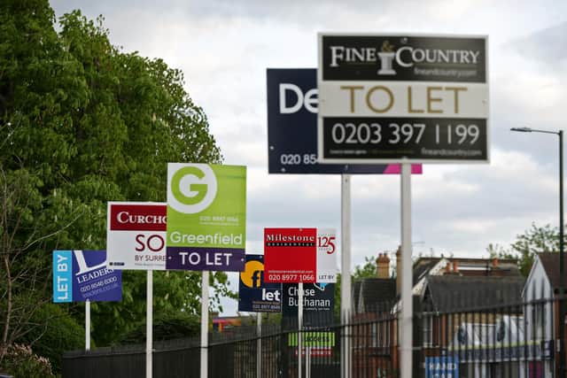A variety of To Let, Let By and Sold estate agent signs outside houses in Richmond upon Thames, London.