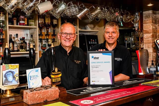 Mike Brown and his son Wayne have been presented with a Long Service Award