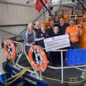 The team from Laver Leisure Ltd present volunteer RNLI fundraisers with their generous donation.