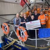 The team from Laver Leisure Ltd present volunteer RNLI fundraisers with their generous donation.
