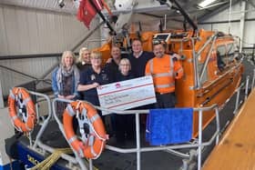 The team from Laver Leisure Ltd present volunteer RNLI fundraisers with their generous donation.