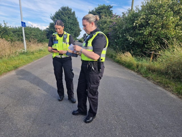 PC Charlotte Redmond and PC Sarah Garbutt logging details from a spot check.