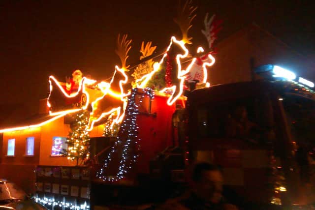 Santa aboard his sleigh flanked by firefighters in Sleaford .