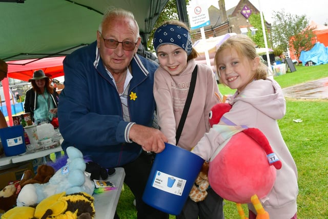 Peter Hooton of Chapel St Leonards on the carnival stand, with Lola Botfield, 9, and Roxie Botfield, 7, of Lincoln.