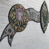 The central crest of the mosaic mural at Dolphin Lane.
