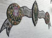 The central crest of the mosaic mural at Dolphin Lane.
