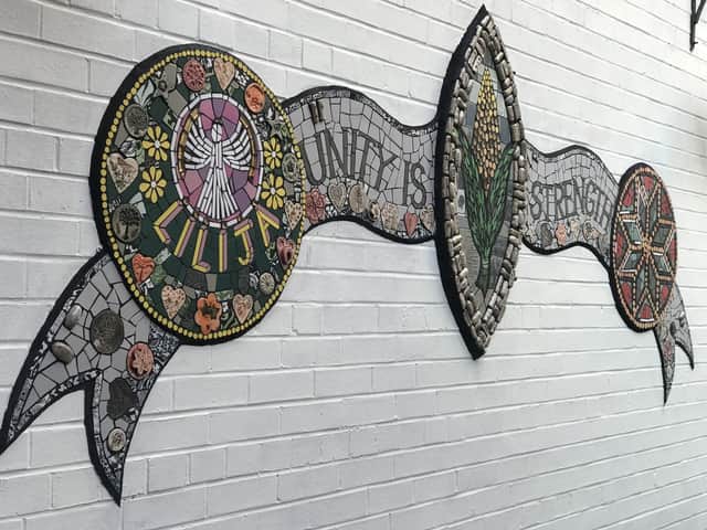 The central crest of the mosaic mural at Dolphin Lane.