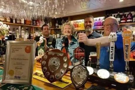 Ye Olde Whyte Swanne landlord and landlady Neil and Dawn Bunch celebrate their CAMRA award in 2024.
