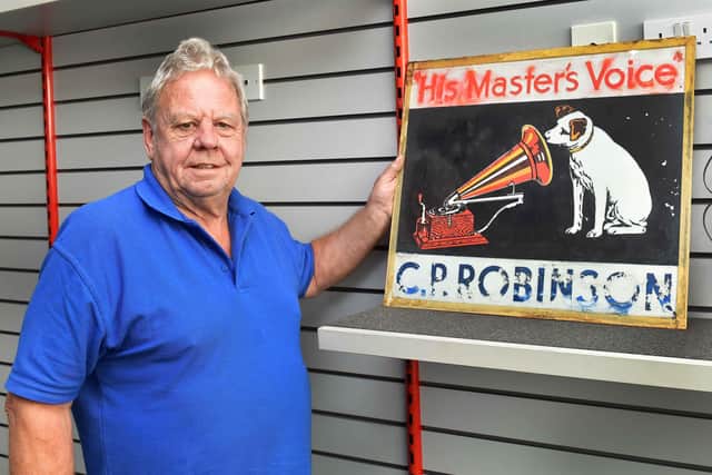 Andy with one of the shop's original signs from the 1930s.