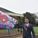 Mayor Coun Adrian Findley in Tower Gardens, Skegness, with the flag celebrating the 80th anniversary of D-Day.