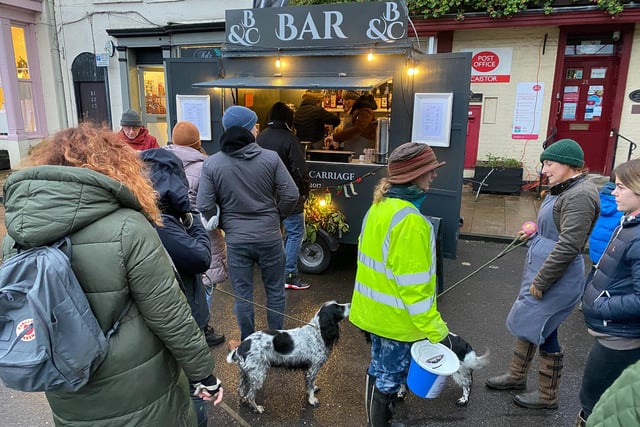Local Dog Walkers wait to buy a glass of warm mulled wine at the locally based Mobile Bar.