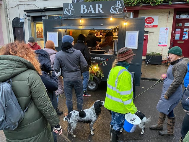 Local Dog Walkers wait to buy a glass of warm mulled wine at the locally based Mobile Bar.