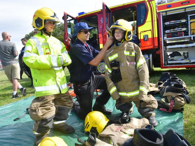 Poppy Dudley 11 and Archie Dudley 6 of South Willingham, in outsized kit with Firefighter Shaun Schwartz of Wragby Fire Station