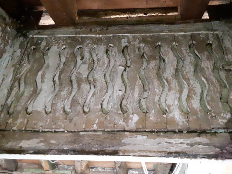 The oddly decorative cut-out pattern above the doorway to the hidden room.