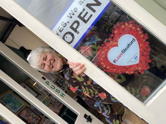 Ruth Burrows at her Art Shop and Studio in Navigation Yard, sporting one of the #LoveSleaford promotional posters.