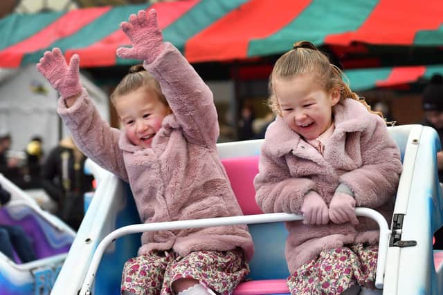 Four-year-old twins Harper and Darcey Blakley enjoying the rides