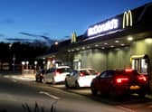 Customers queue at a McDonald's drive through restaurant (Photo by David Rogers/Getty Images).