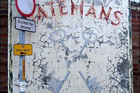 How the battered 'ghost sign' looked before the restoration.