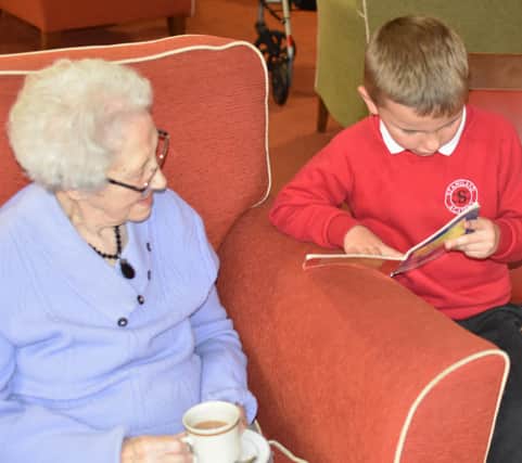 A Staniland Academy pupil takes a resident through a story.