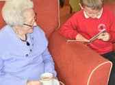 A Staniland Academy pupil takes a resident through a story.