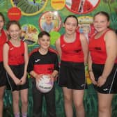 Vicky Morris (left) sponsor and owner of EmpowHer and Emily Smith (teacher) with Church Lane School's netball team and their new kit. Photo supplied