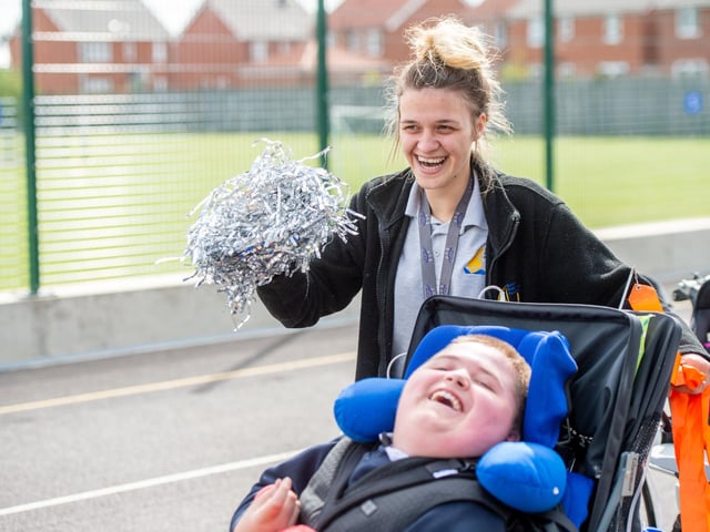 A pupil and staff member smile at the opening event at Boston Endeavour Academy.