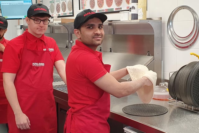 Tossing the pizza dough in the kitchen at Papa Johns, Sleaford.