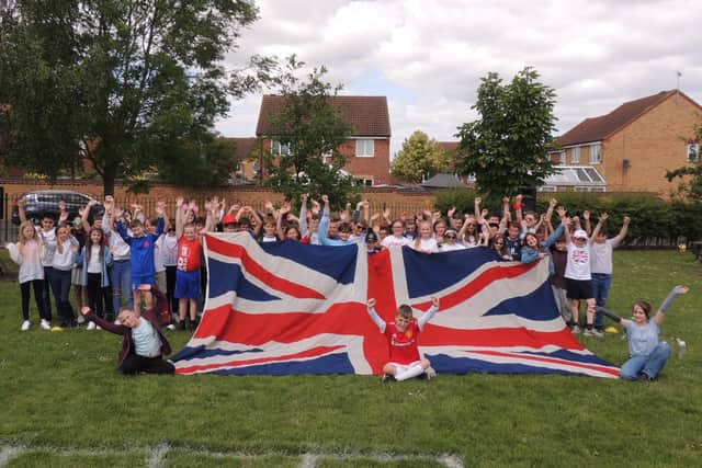 Year 6 pupils at St Botolph's School, Quarrington with the enormous Union flag at their jubilee event.