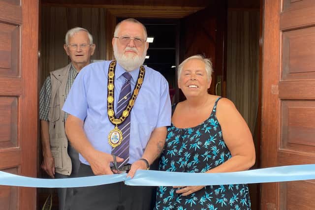 Cutting the ribbon.