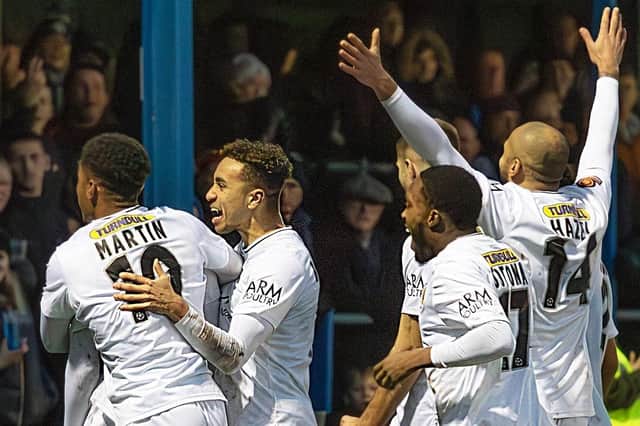 Boston United players celebrate their win at the end of the Boxing Day match with Kings Lynn Town FC.