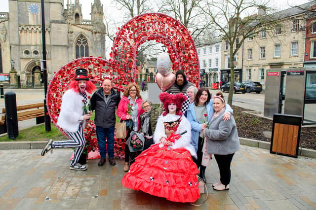Rhubarb Theatre characters handed out flowers around the heart seat on Sleaford Market Place. Photo: NKDC