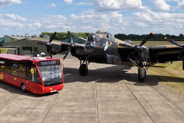 The new B617 bus stands alongside an RAF Lancaster bomber at the service's launch. (PHOTO BY: Lincolnshire County Council)