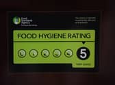 A Food Standards Agency rating sticker on a window of a restaurant in central London. A huge variation in food hygiene standards remains across the UK, with one in five high or medium-risk food outlets failing to meet standards, according to a study.