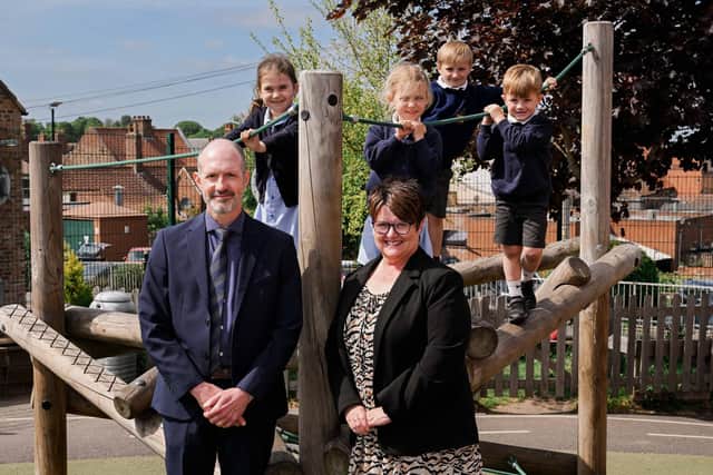 Dr Dunn and Mrs Cook with (left to right) Maisie, Evelyn, Teddy and Eden on some of the outdoor equipment in Early Years.