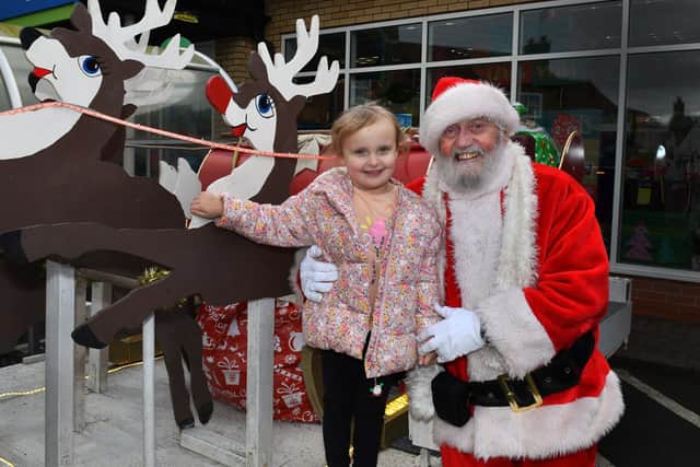 Santa with Sophie Hearth, 5, at Coningsby.