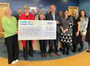 Lucy Burnip (left), of the Stroke Association, accepting the donation at Chattertons' Lincoln office.