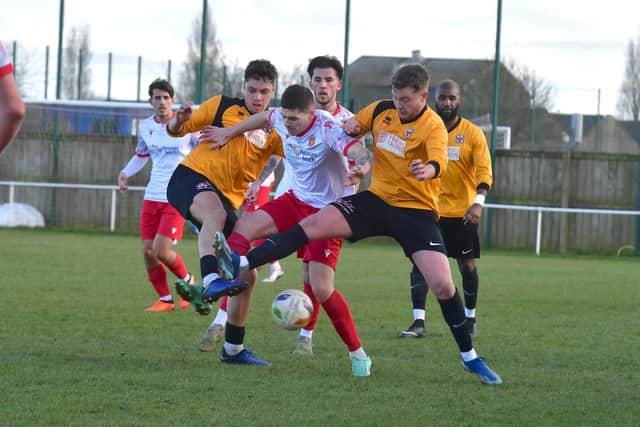 Action from Saturday's game, with Eastwood having to wear Skegness's yellow away kit.