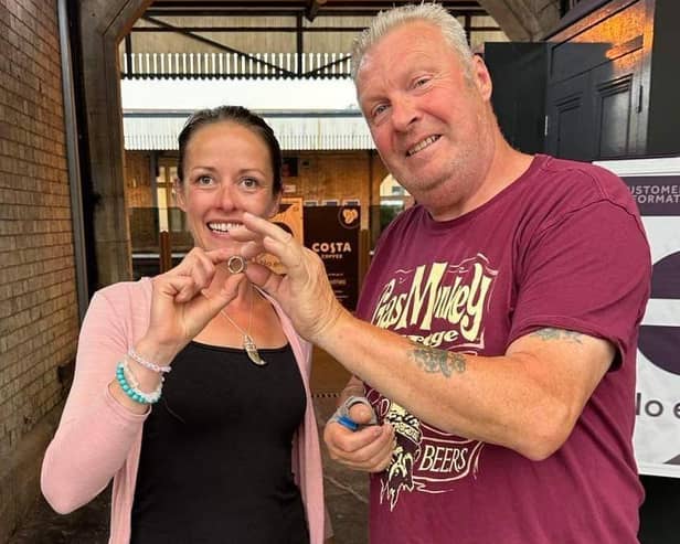 Liz Thornton is reunited with her precious feather ring by metal detector Don Graves.