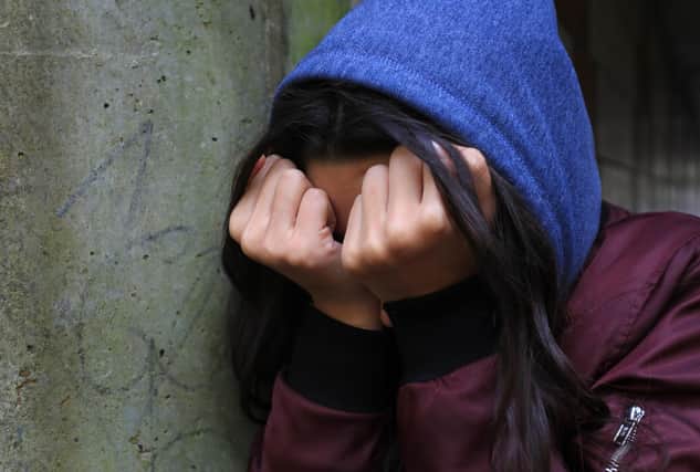Embargoed to 2330 Wednesday March 10 PICTURE POSED BY MODEL File photo dated 02/02/20 of a teenage girl with her head in her hands. There are "concerning signals" about the effect of the pandemic on children and young people, researchers have said.