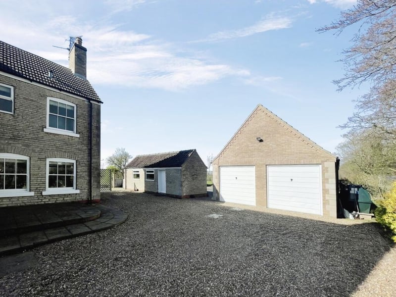 The triple garage and separate outbuilding.